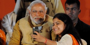 Chief Minister of the Indian state of Gujarat and Bharatiya Janata Party (BJP) prime ministerial candidate Narendra Modi (L) poses for a photograph as party candidate from Mumbai Poonam Mahajan takes a 'selfie' with him at an election rally in Mumbai on April 21, 2014. India's 814-million-strong electorate is voting in the world's biggest election which is set to sweep the Hindu nationalist opposition to power at a time of low growth, anger about corruption and warnings about religious unrest. AFP PHOTO/INDRANIL MUKHERJEE (Photo credit should read INDRANIL MUKHERJEE/AFP/Getty Images)