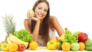 beautiful young woman with fruits and vegetables, isolated on white