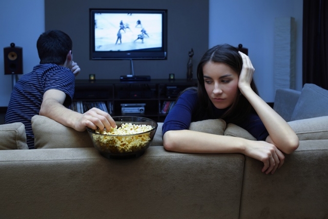 Couple-watching-TV-woman-upset