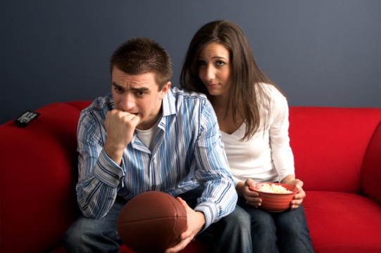 bored-woman-watching-football-with-husband